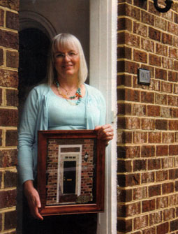 photo of Nancy Asmus holding an applique